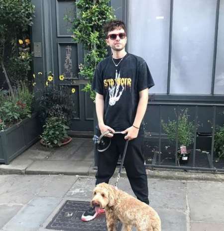 Finlay Munro Kemp chilling with his pet dog. 